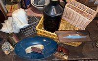 Overview photo of assortment of baskets, serving dish, crib blanket, metal lamp, and other small decorative items.