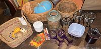Photo showing assortment of fall decor items including decorative gourds, baskets and candle holders