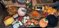 Wide view of entire fall and Halloween assortment including wigs, pumpkins, leaf garlands, signs, and other decor.