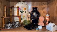 All items displayed including large oriental vase, bust sculpture, Betty White jar and others