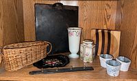 Overview showing all items including wicker basket, metal tray, floral vase, ceramic jar, decorative tray, metal buckets, and wooden cutting board.