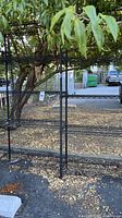 Metal wire rack outdoor, showing overall structure and weathered condition.