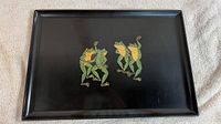 Full view of the black rectangular serving tray with dancing frogs design in center.