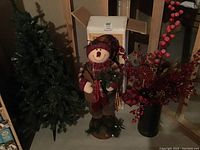 Photo showing the full lot with the small artificial tree, snowman figure, and metal container with picks.