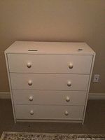 Front view showing all four drawers and knobs.