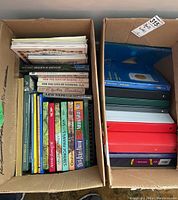 Two cardboard boxes; one with hardcover books mostly on nature, Judaica, cooking, the other with various binders and a box of sheet protectors.