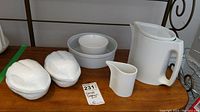 Lot showing two ceramic walnut-shaped bowls with lids, small white ceramic bowl, Pier 1 ceramic bowl, Dansk ceramic creamer, and white Dansk teapot.