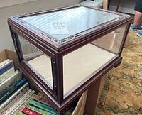 Angled front view showing wood frame and glass panels on three sides