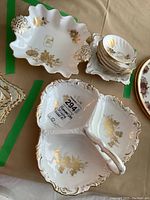 Photo of three-section divided server, rectangular dish, and stack of small serving bowls on table