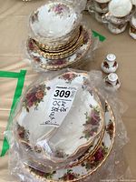 Stacks of plates wrapped in plastic with MaxSold label