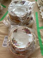 Stacks of dinner and salad plates wrapped in plastic