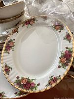 Close-up image of oval serving platter showing floral pattern and gold trim of Royal Albert Old Country Roses