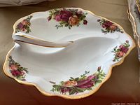 Close-up of small divided hostess serving dish with Royal Albert Old Country Roses floral pattern and gold edges.