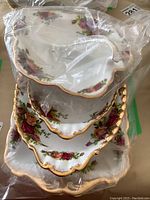 Stacked view of the five Old Country Roses hostess dishes showing floral pattern and gold detailing