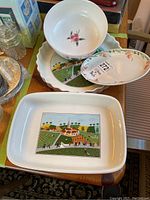 Four pieces of porcelain including a baking dish, pie dish, bowl, and a small dish shown on a table.