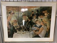 Frontal view of framed Renoir poster showing the entire artwork and frame with reflections on the glass.