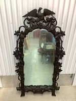 Full front view of carved ebony wood mirror