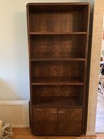 Full front view of bookshelf showing all shelves and cabinet doors