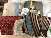 Curtain and shower curtain fabric samples with various colors and patterns, including stripes, florals, and textures