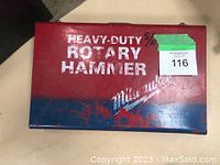 Closed red metal case labeled 'Heavy-Duty Rotary Hammer' and Milwaukee logo.