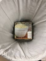 Popcorn bowl with original box in a white fabric hamper