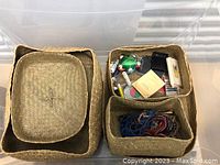 Three nesting woven baskets viewed from above, one filled with sewing notions including threads, scissors, and mending supplies