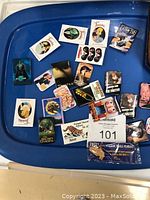 Overview of loose vintage movie pins displayed on a blue tray showing various titles and characters