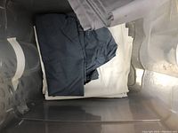 Black and white fabric folded in a plastic bin