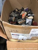 Box containing many shoemakers supplies including boxed Biltrite heels and loose items inside a cardboard box