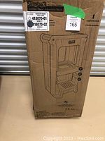 Box of Simplay3 Toddler Tower Adjustable Step Stool with printed illustration and product info.
