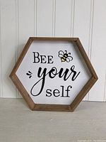 Front view of the hexagonal 'Bee yourself' sign showing the bee graphic and text.