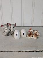 Three distinct sets of salt and pepper shakers displayed together showing all six pieces.