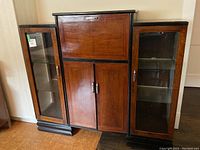 Front elevation showing overall design, wood finish, chrome handles and side glass cabinets