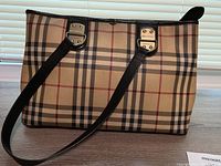 Front exterior view showing Nova check pattern and shoulder straps