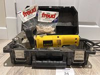 Photo of DeWalt biscuit joiner in carrying case with two packages of Freud biscuits in background.