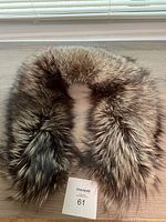 Silver fox fur collar laid flat, showing its full length and plush texture with a MaxSold lot number card.