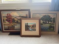 Three acrylic landscape paintings on board, one signed E.A. Leis and another Geo H. Wolfe, various frame sizes and styles