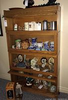 Front view of oak barrister bookcase filled with sample contents