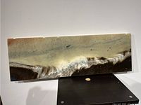 Full front view of the abstract resin art on wood board showing wave-like patterns in beige, cream, brown, and black tones.
