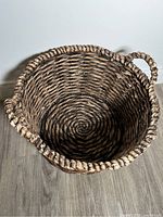 Top view of large woven basket showing circular base and weave pattern.