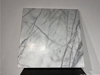 Top view showing smooth polished surface of white and gray veined marble slab.
