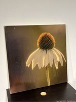Front view of the resin-coated flower art showing the flower centered on the panel with a reflective surface.