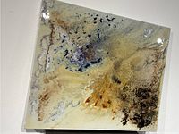 Flat front view showing abstract resin design with beige, black, blue, and rust colors.