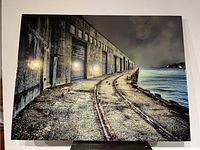 Front view of resin photo art showing industrial waterfront and railway tracks with light reflections on resin surface.
