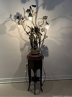 Full front view of illuminated lamp on wooden pedestal