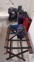 Photo of the luggage rack in front showing multiple soft and hard sided cases behind it.