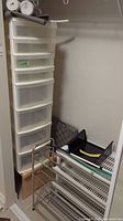 Tall eight-drawer white plastic storage unit, metal rack, plastic shoe racks, wooden shelf, and collapsible crate grouped together in a storage closet area.