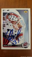 Front side of signed Andre Racicot hockey card showing portrait and autograph