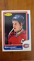 Front of Bob Gainey hockey card showing player portrait in Canadiens uniform with signature.