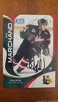 Front photo of Brad Marchand hockey card showing player on ice in Halifax Mooseheads uniform, signed in black marker.